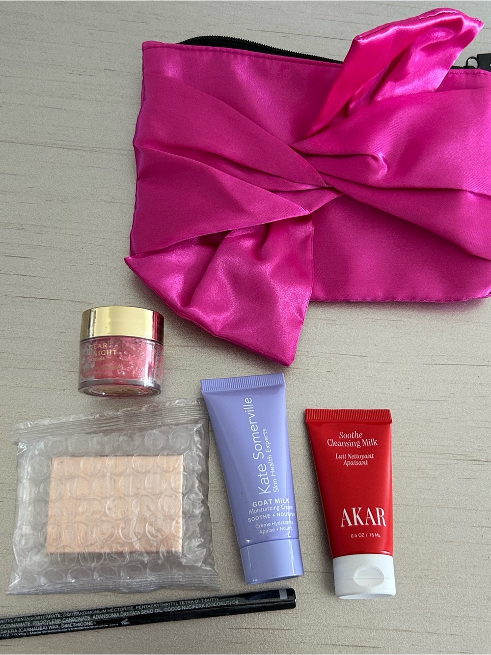 5 Premium Skincare Beauty Products in a satin Fuchsia Pouch
